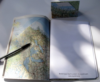 Recycled notebooks and card holders made from outdated maps
